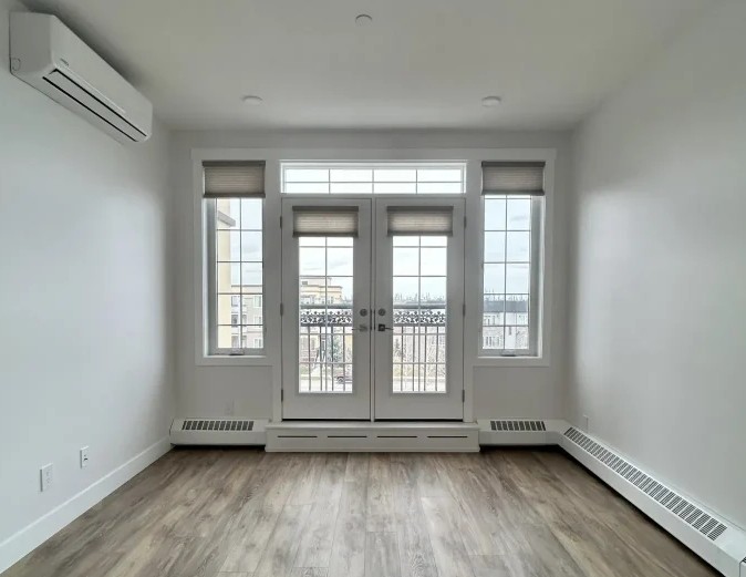 Professional Interior Painters Calgary applying paint with precision in a residential living room.