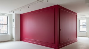 Exterior trim painting contrasts beautifully with the vibrant red wall in a minimalistic room
