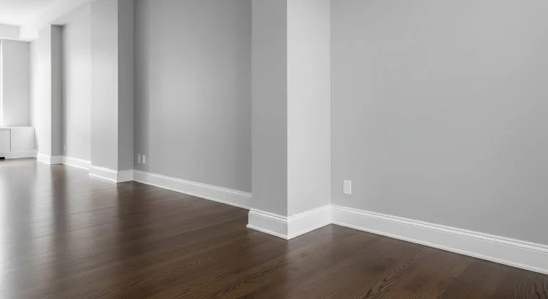 Freshly painted baseboards and walls in an empty modern interior for a clean look
