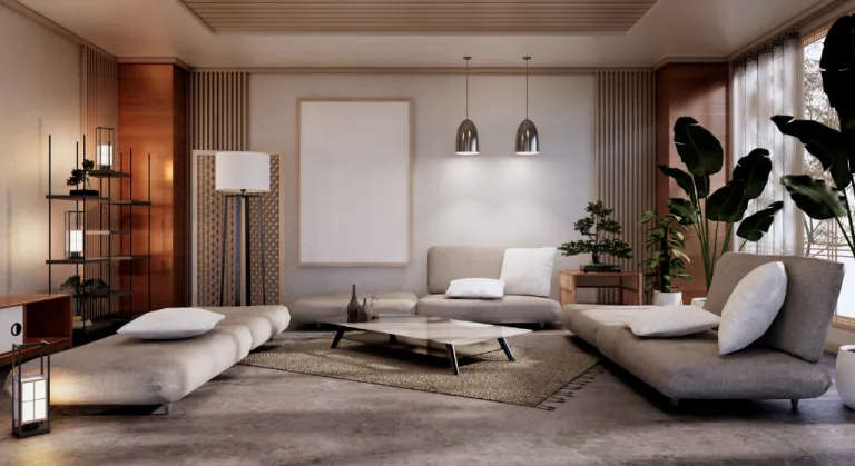 A modern, minimalist living room features neutral furnishings and abundant greenery