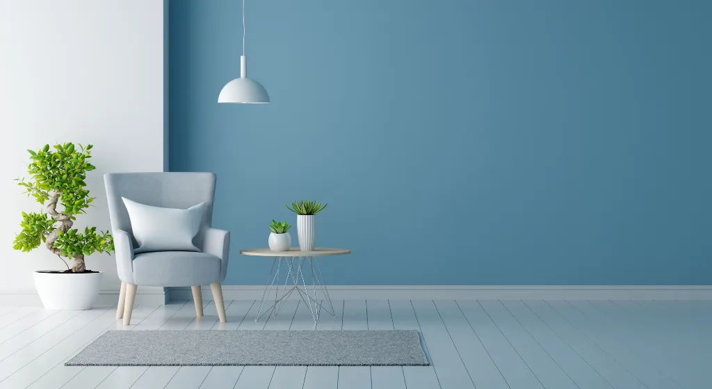 Accent wall painting in Calgary enhances a cozy seating area with a light blue hue and decorative plants