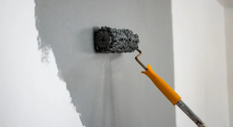Interior Painter Copperfield using a roller to apply gray paint on a wall